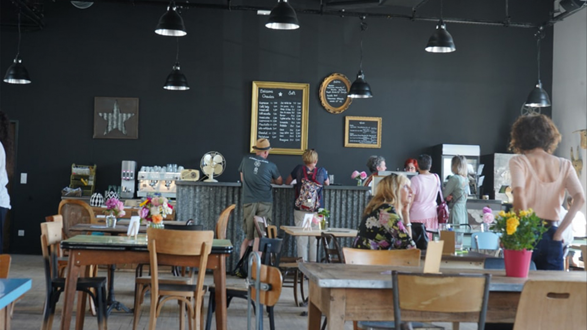 la zone café avec des personnes animant le lieu et des clients